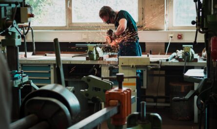 selective focus photography of man using angle grinder