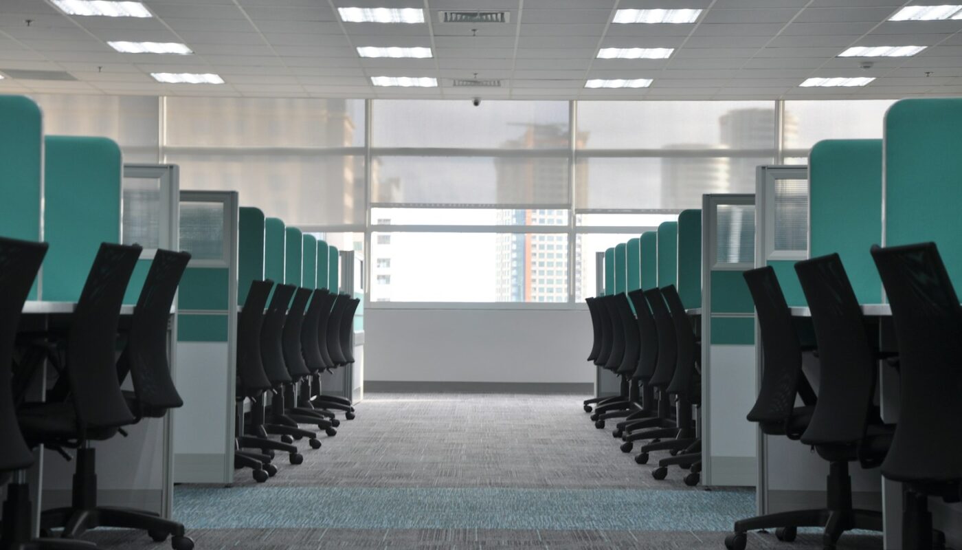 empty black rolling chairs at cubicles