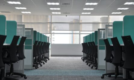 empty black rolling chairs at cubicles