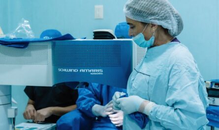 Medical professionals performing eye surgery in a sterile clinic environment.